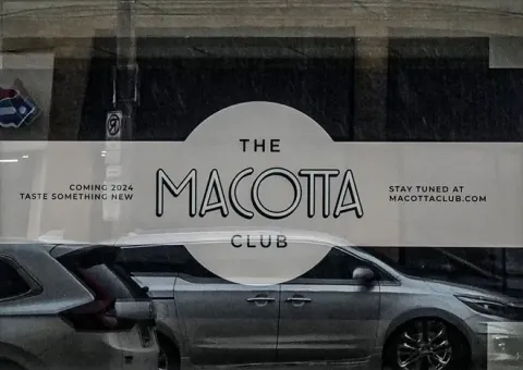 Macotta Club sign on window